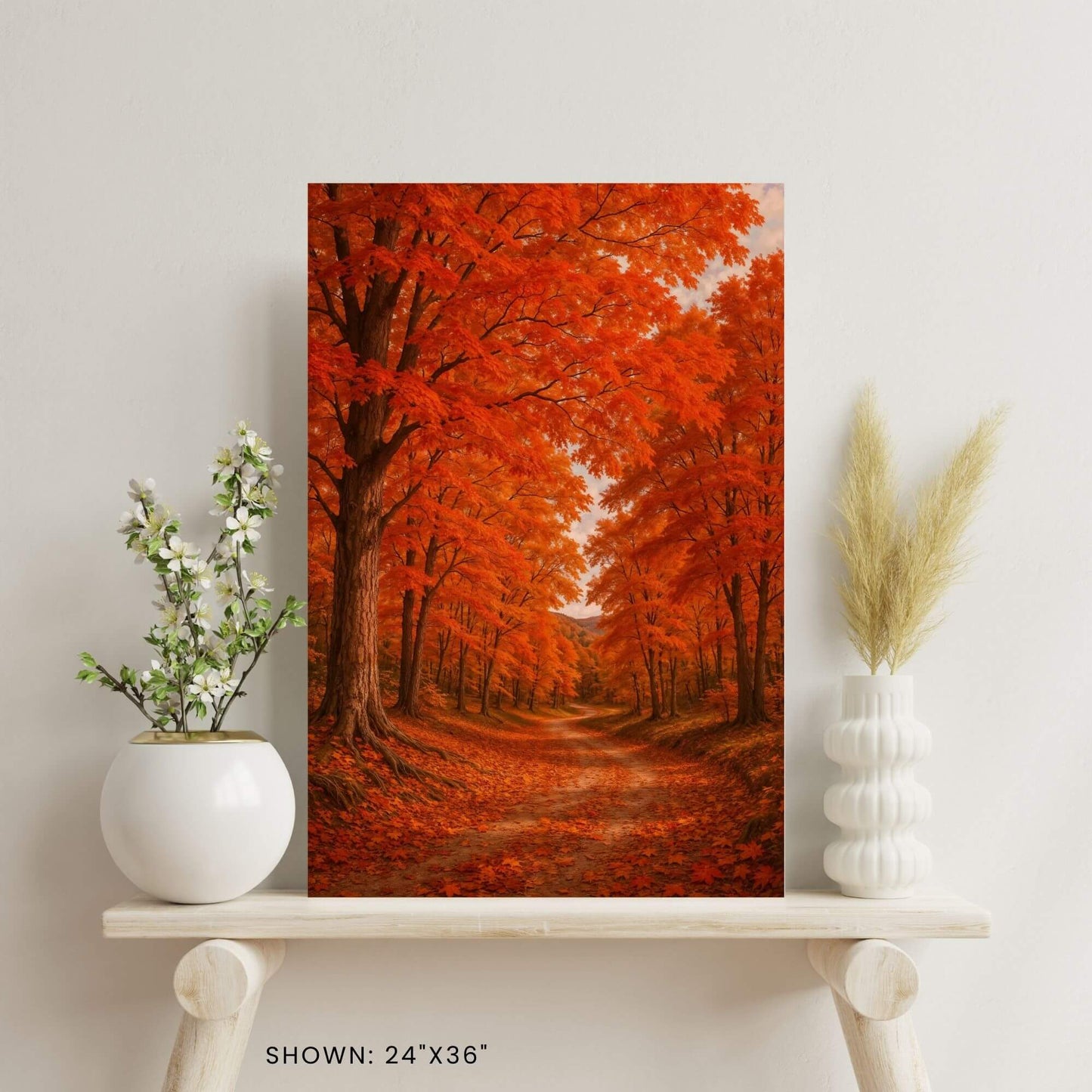 24 × 36-inch fall foliage forest canvas print styled on a minimalist shelf with ceramic vase florals and pampas grass.
