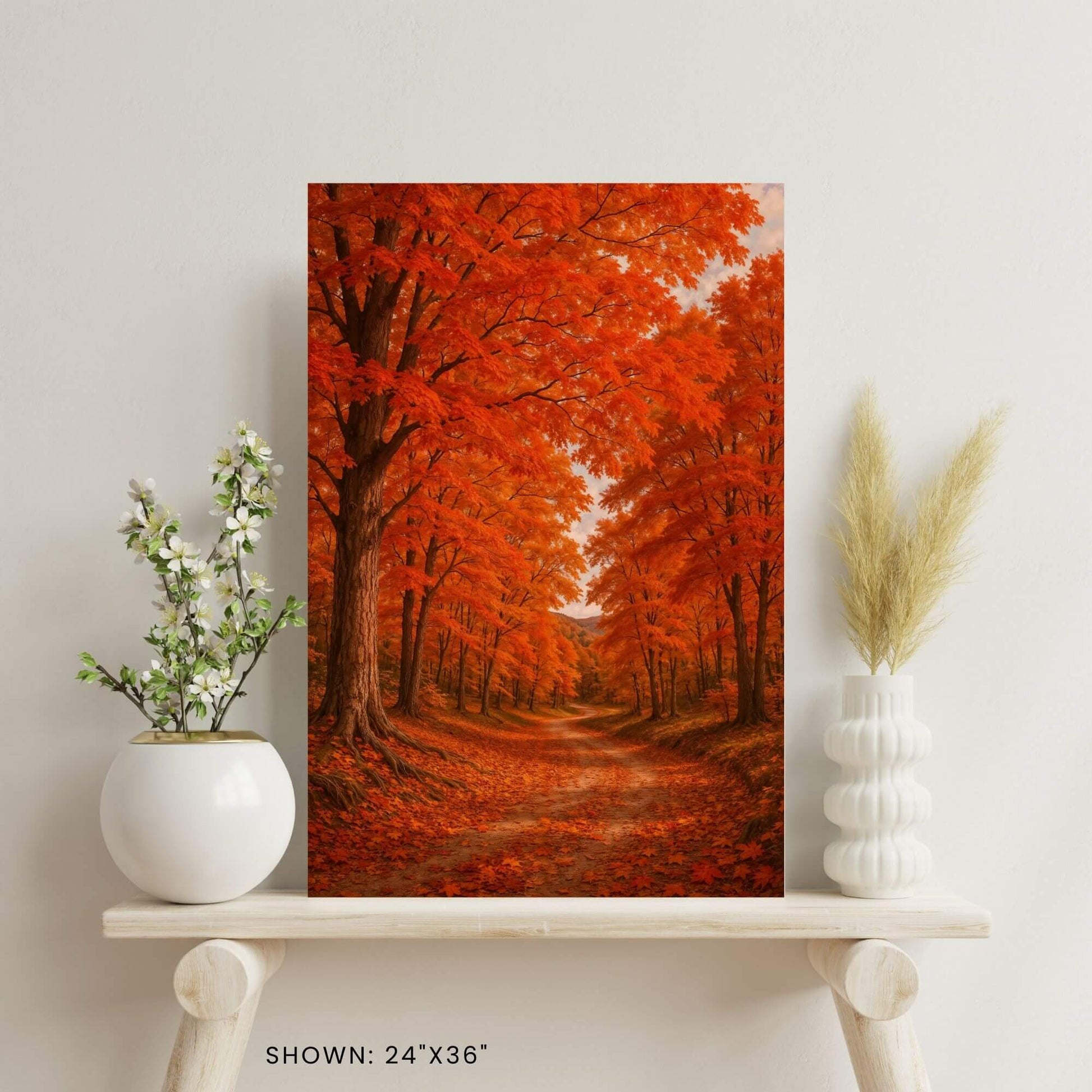 24 × 36-inch fall foliage forest canvas print styled on a minimalist shelf with ceramic vase florals and pampas grass.