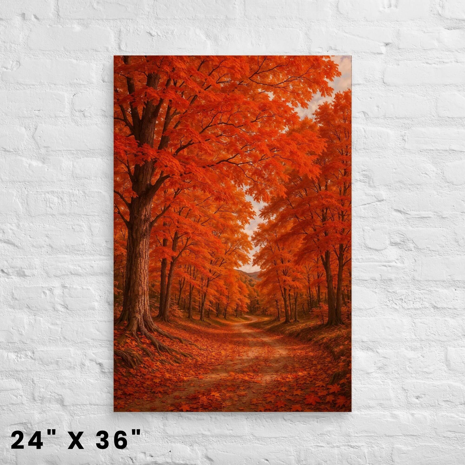 24 × 36-inch vibrant autumn maple forest canvas print with fiery orange foliage arching over a woodland path on a bright white-brick wall.
