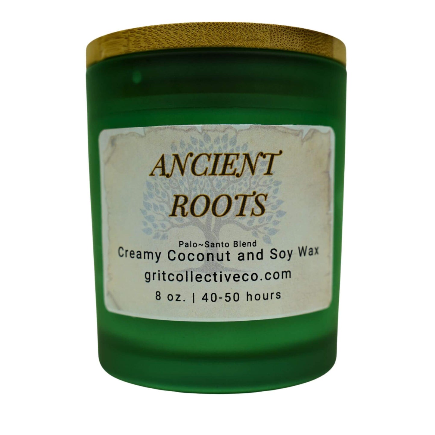 Ancient Roots" Palo Santo Blend creamy coconut and soy wax candle by Grit Collective Co. in a green glass jar with a tree design label and bamboo lid.