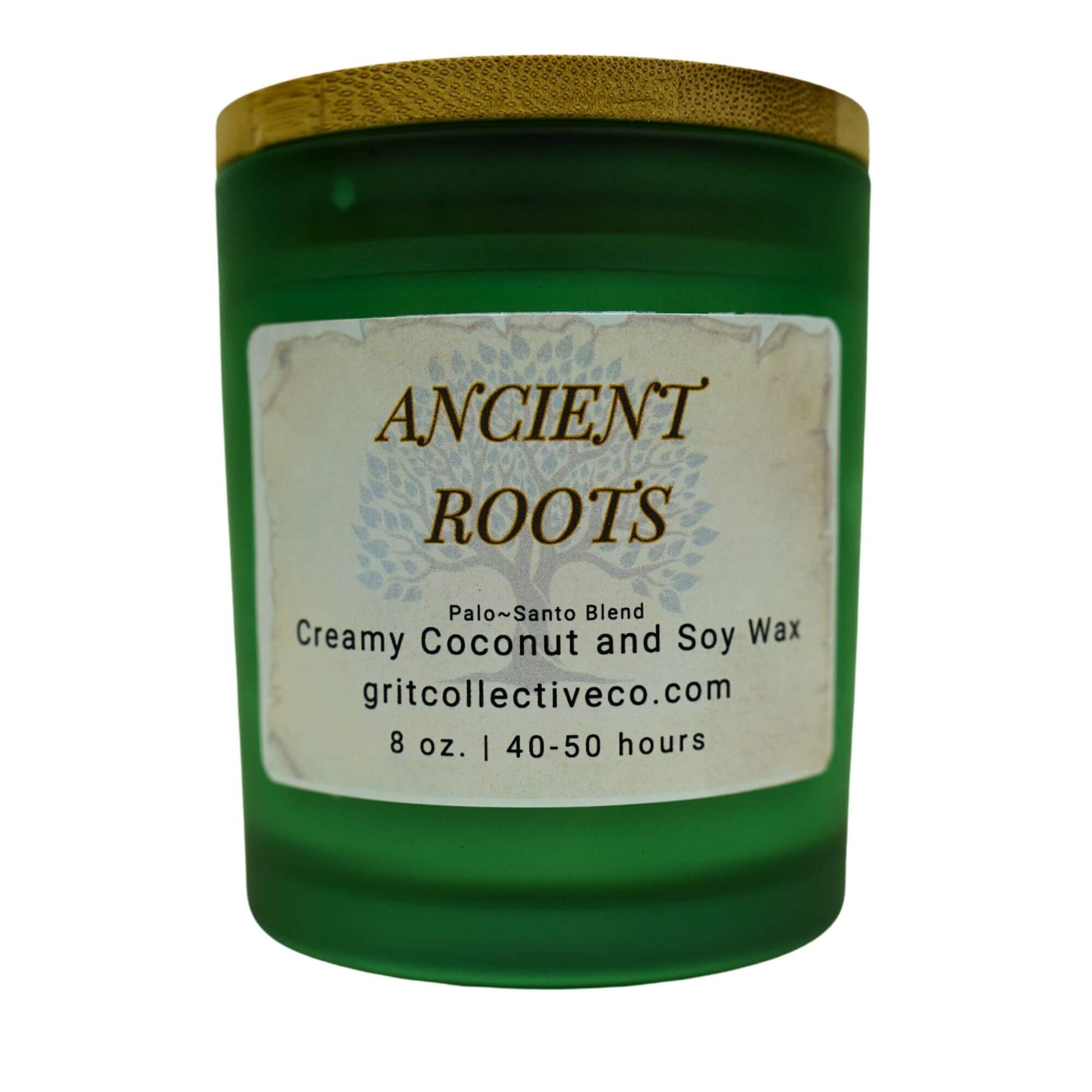 Ancient Roots" Palo Santo Blend creamy coconut and soy wax candle by Grit Collective Co. in a green glass jar with a tree design label and bamboo lid.