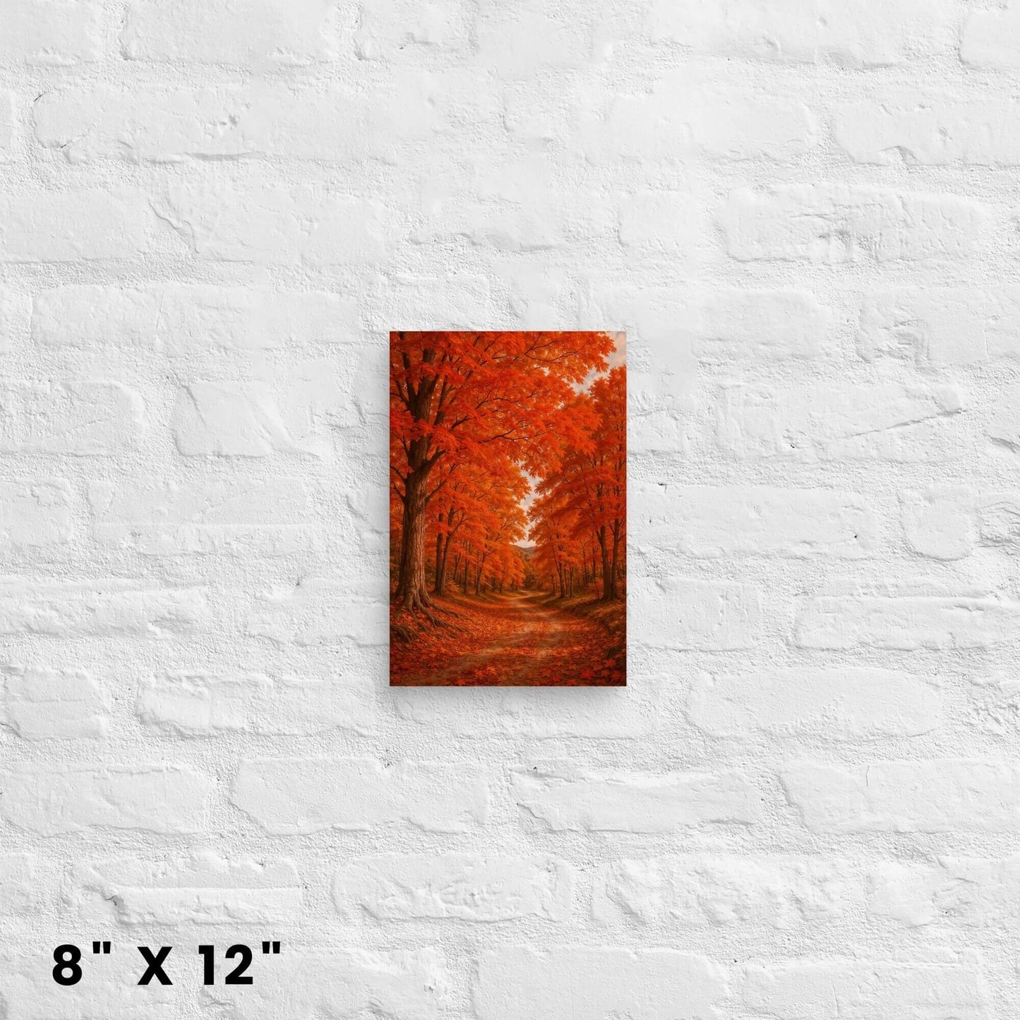 8 × 12-inch mini autumn forest canvas accent showcasing fiery orange leaves and rustic trail against a white-brick backdrop.