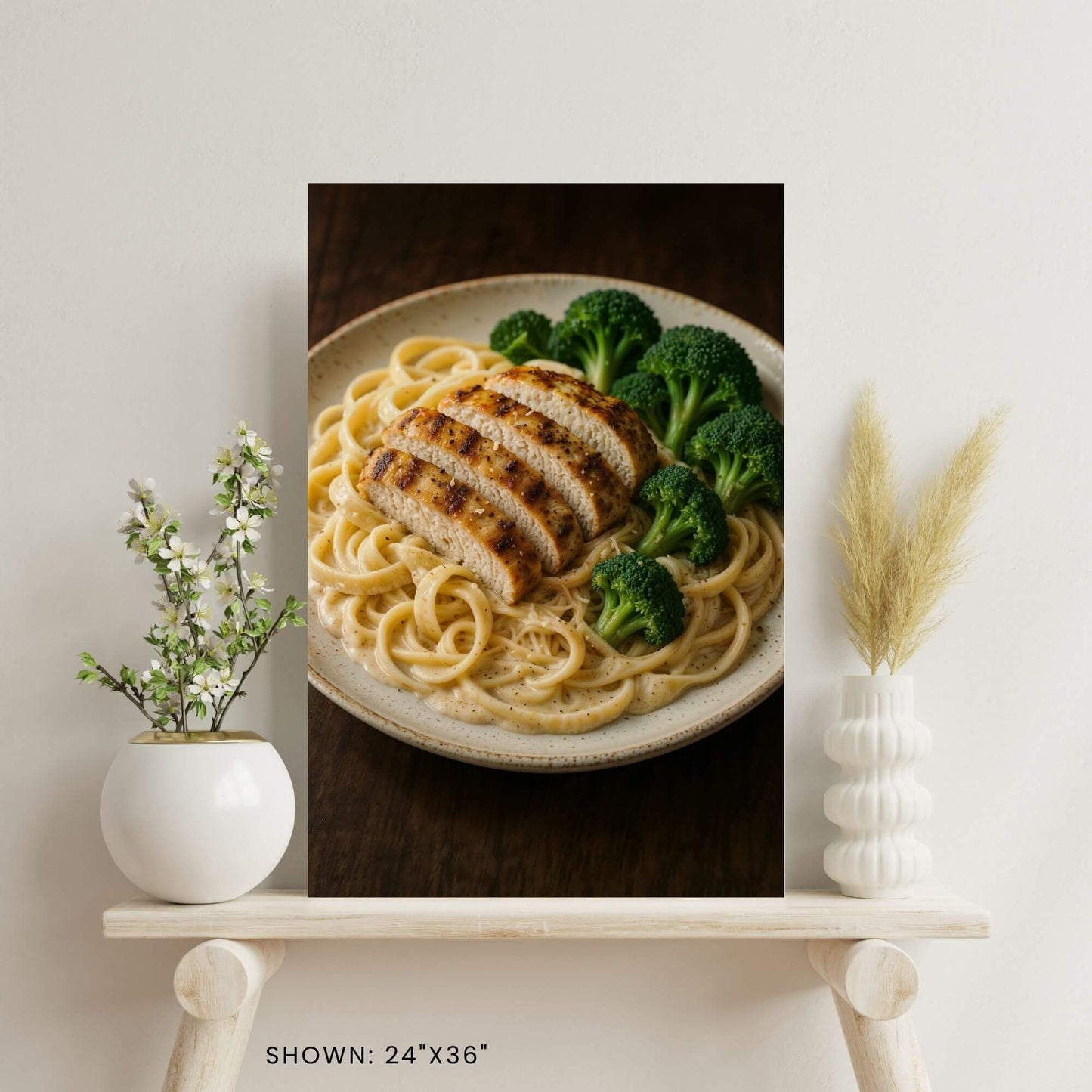 24"x36" canvas print featuring a plate of chicken Alfredo pasta and broccoli, shown on a
decorative shelf.