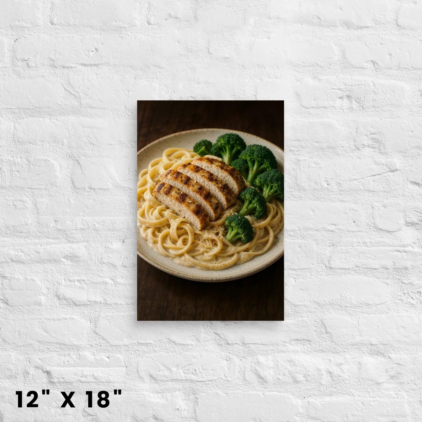 12"x18" canvas print of chicken alfredo pasta with broccoli on a plate, mounted on a white
brick wall.