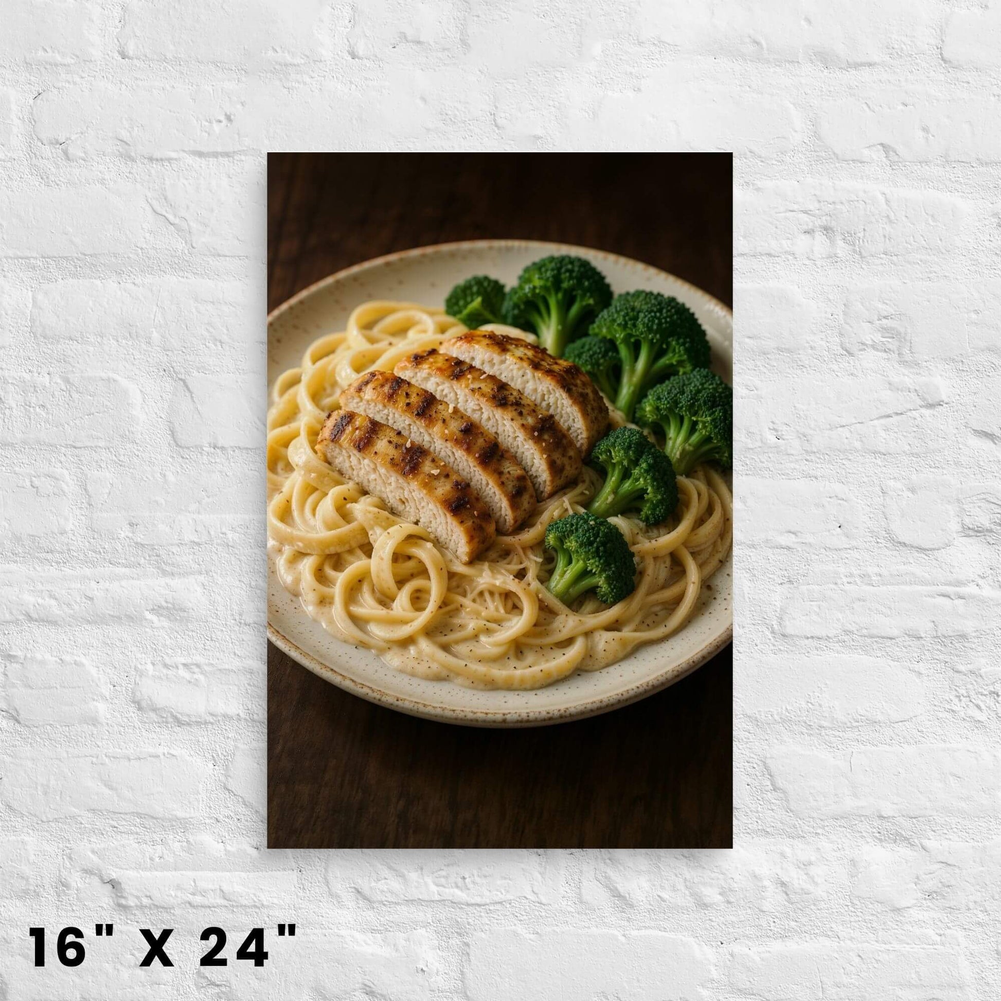 16"x24" canvas print featuring a close-up of chicken alfredo pasta with grilled chicken and
broccoli, displayed on a white brick wall.