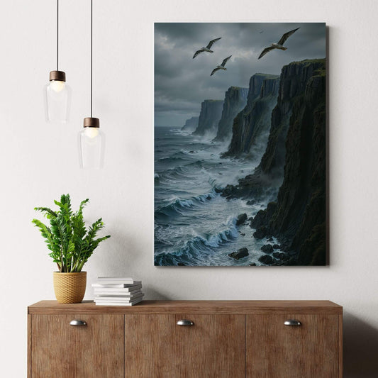 Canvas print of a dramatic coastal landscape with cliffs and seagulls, placed on a wooden dresser with a plant, suitable for coastal or seascape decor.