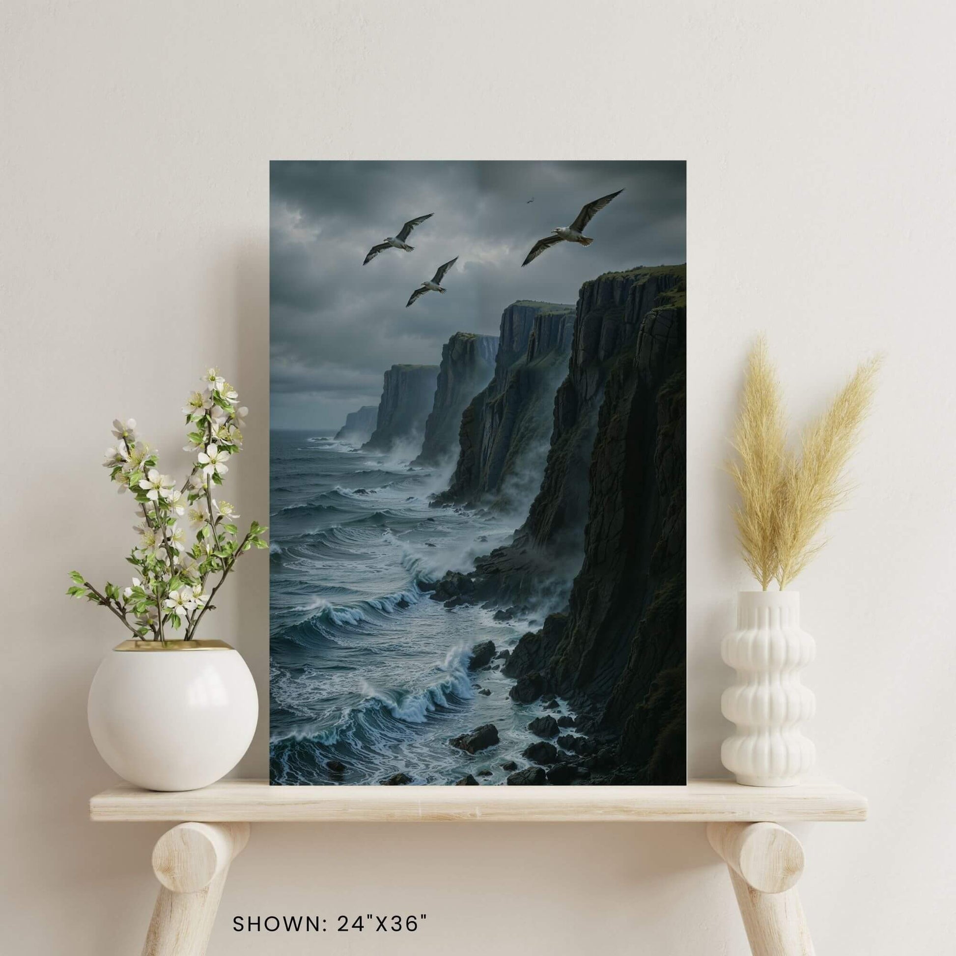 24"x36" canvas print featuring a dramatic seascape with cliffs, waves, and seagulls, shown on a decorative shelf.