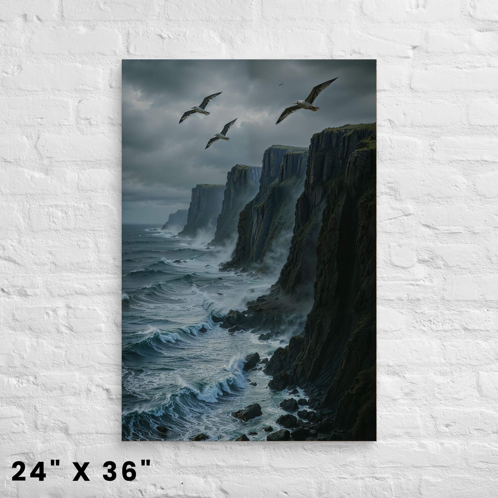 24"x36" canvas print depicting a rugged coastline with cliffs, crashing waves, and flying seagulls, mounted on a white brick wall.