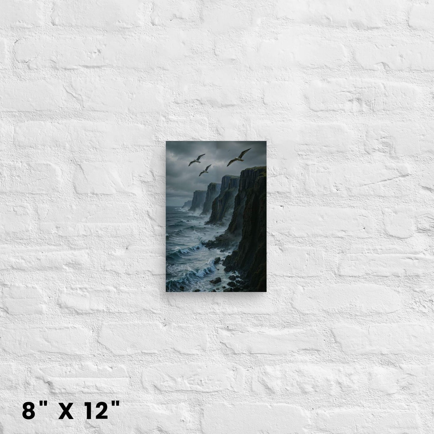 8"x12" canvas print showcasing a dramatic view of coastal cliffs, waves, and seagulls, hanging on a white brick wall.