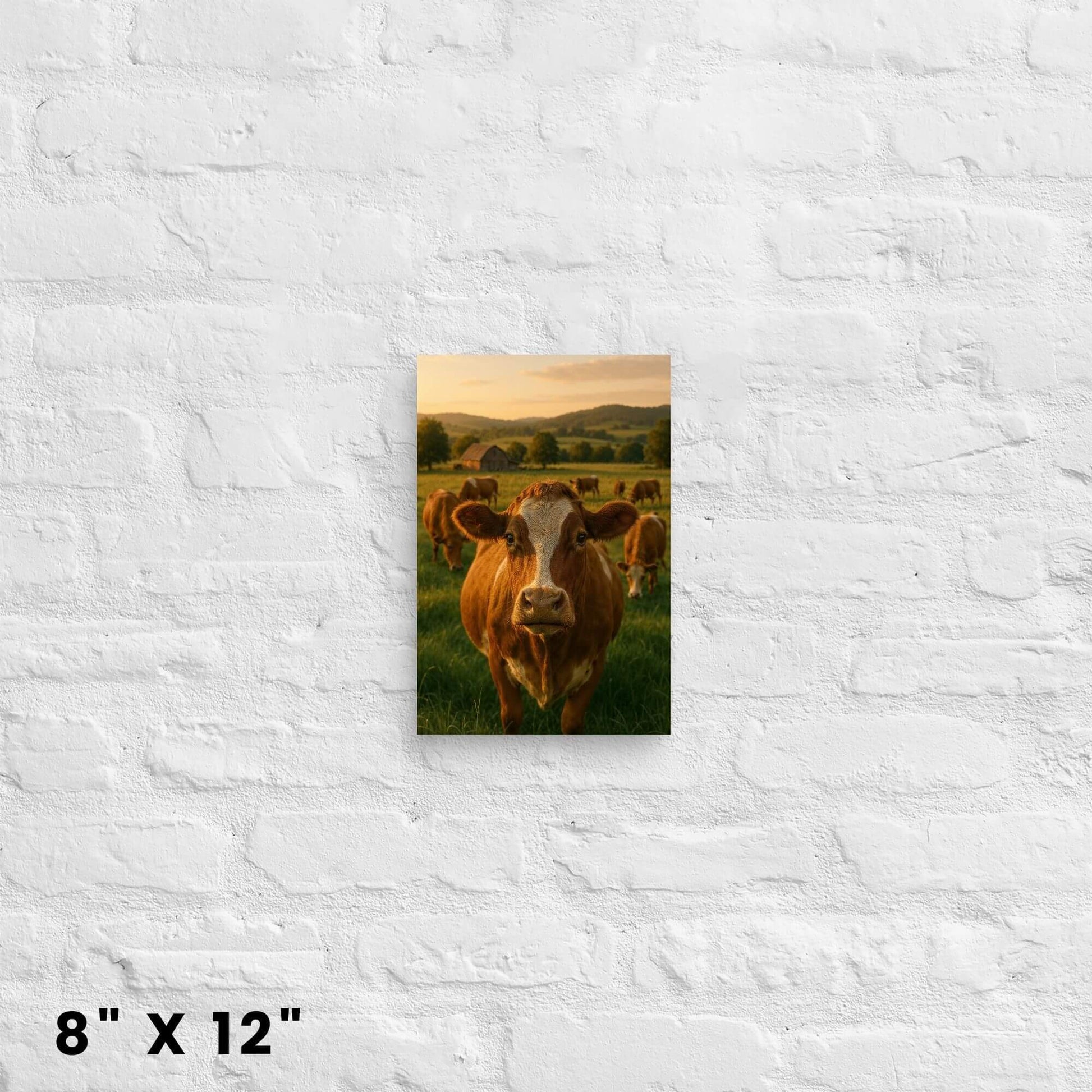 Animal art print on canvas sized 8x12 inches: a cow face in a meadow with a barn background, on a brick background.