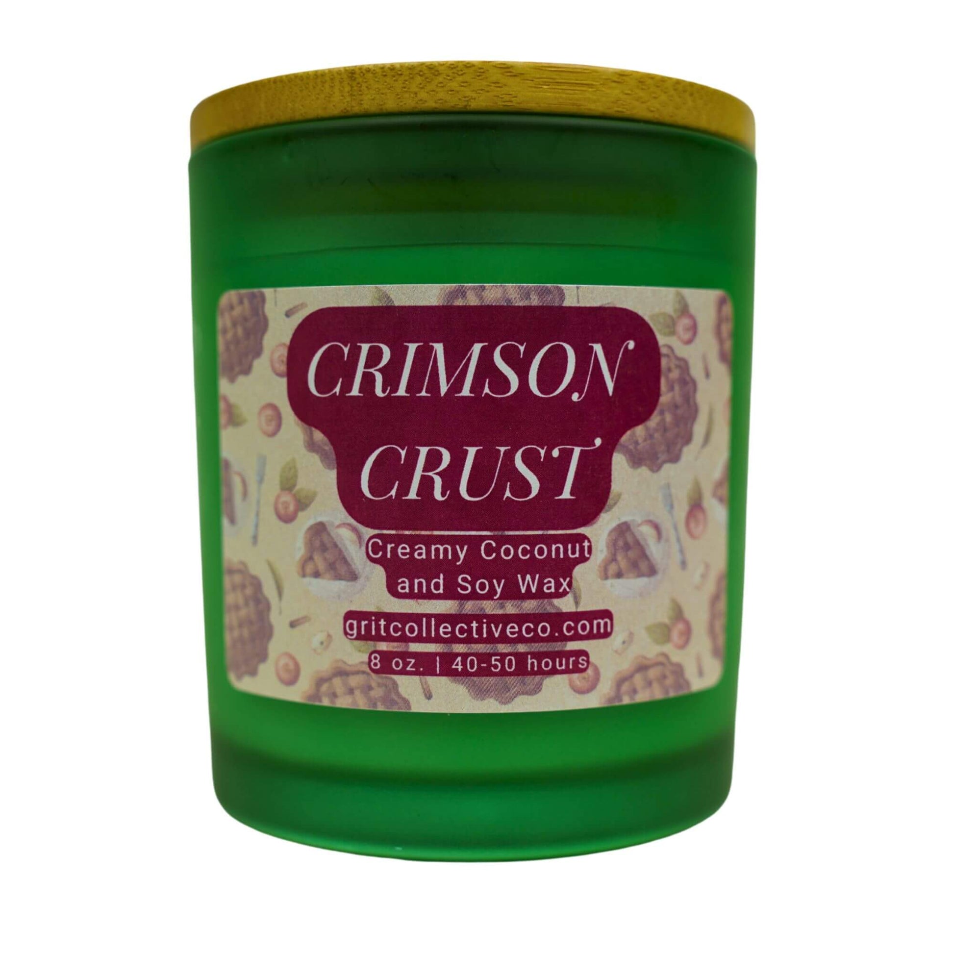 Crimson Crust" creamy coconut and soy wax candle by Grit Collective Co. in a green glass jar with a pie-themed label and bamboo lid.
