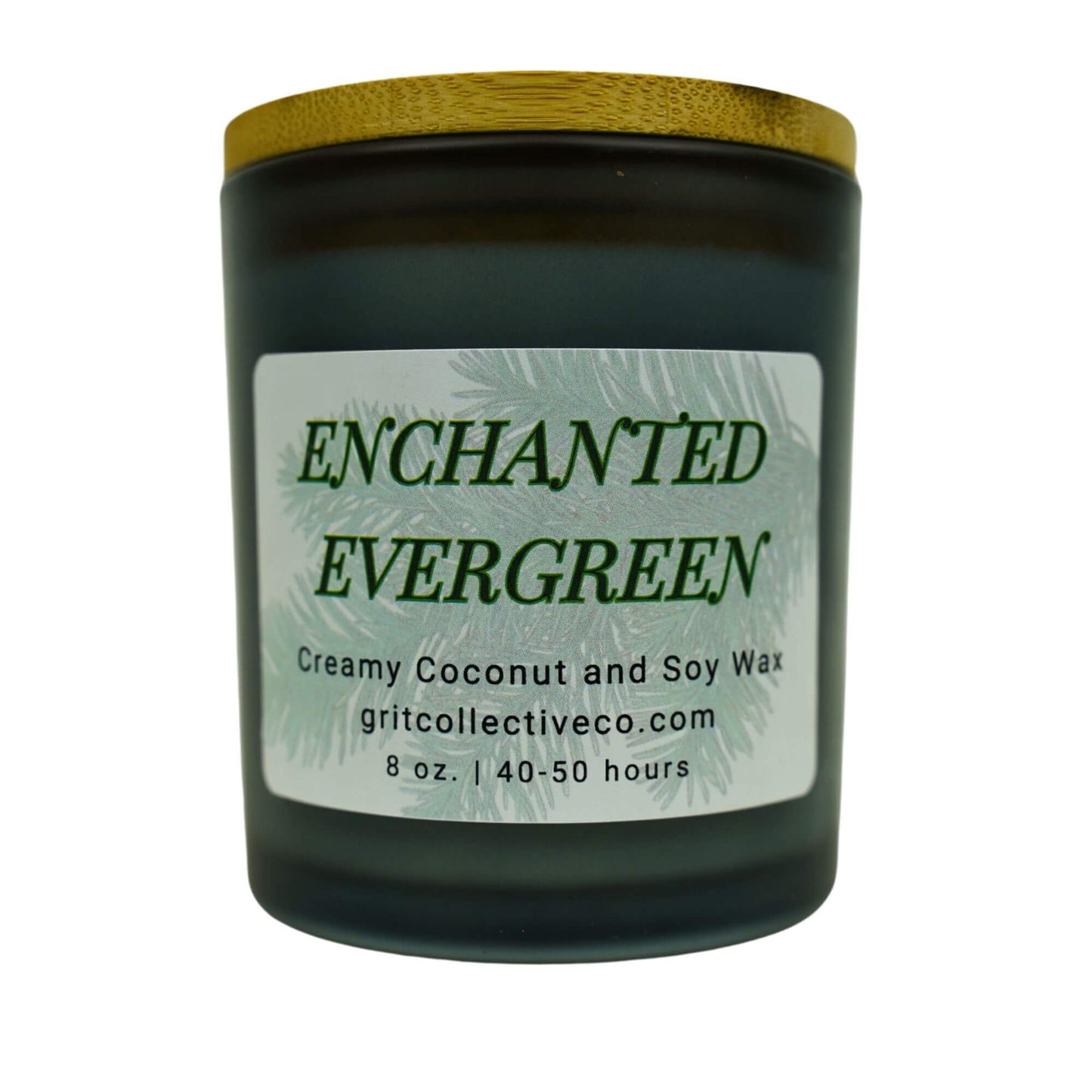 Enchanted Evergreen" creamy coconut and soy wax candle by Grit Collective Co. featuring an evergreen tree design and wooden lid.