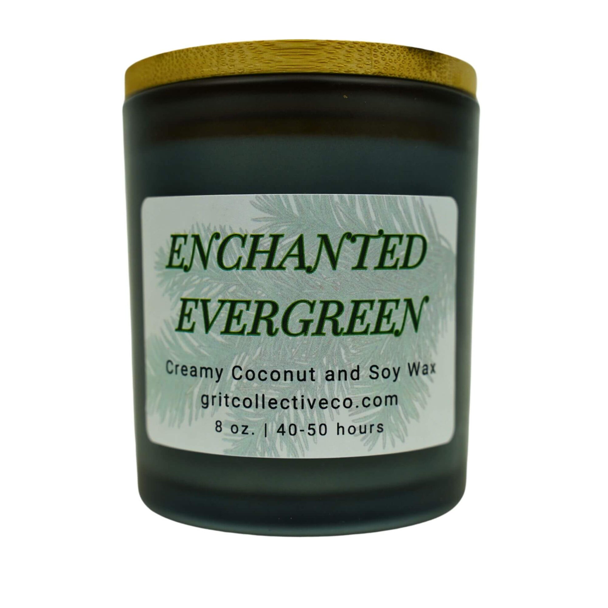 Enchanted Evergreen" creamy coconut and soy wax candle by Grit Collective Co. featuring an evergreen tree design and wooden lid.