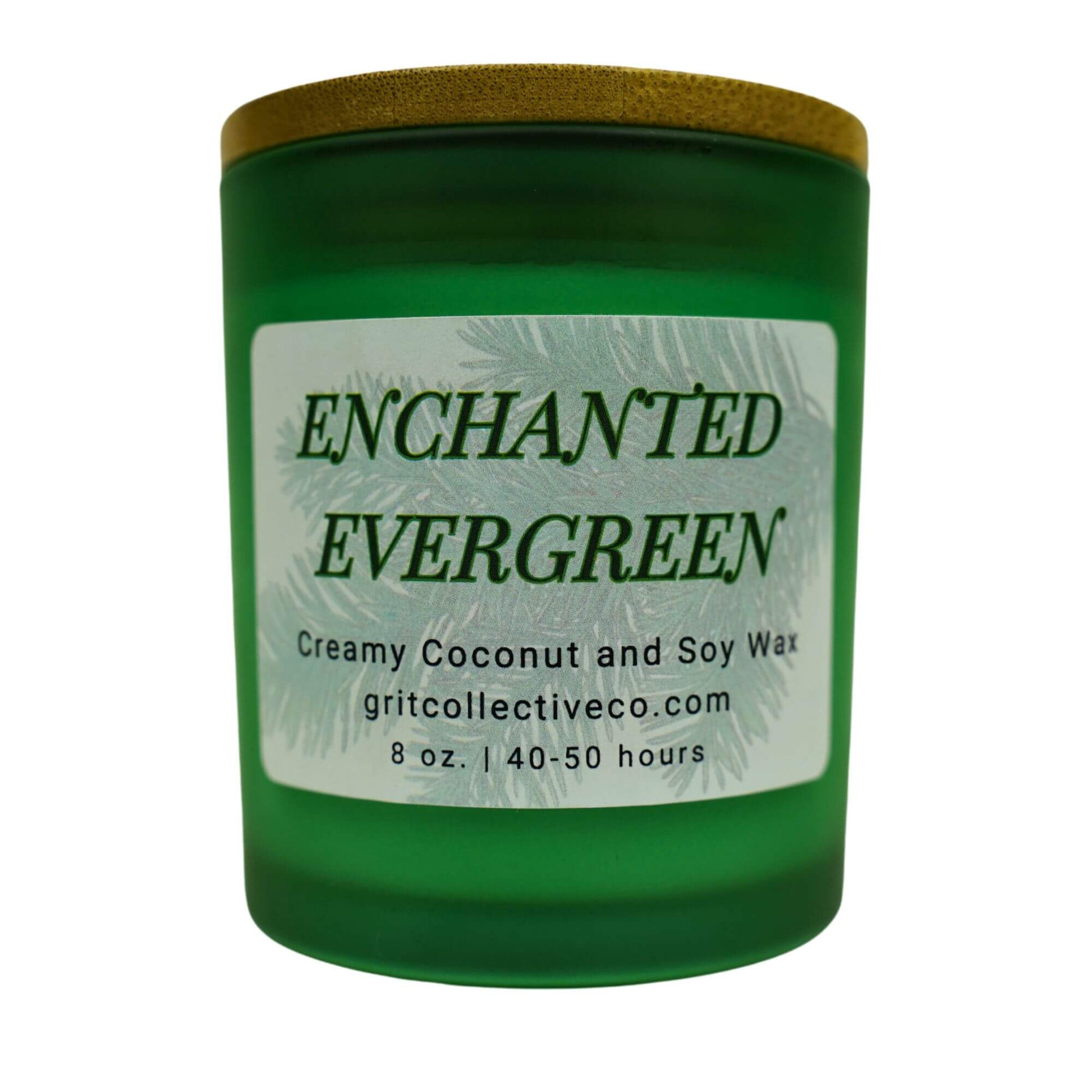 Enchanted Evergreen" creamy coconut and soy wax candle by Grit Collective Co. in a green glass jar with an evergreen label and bamboo lid.