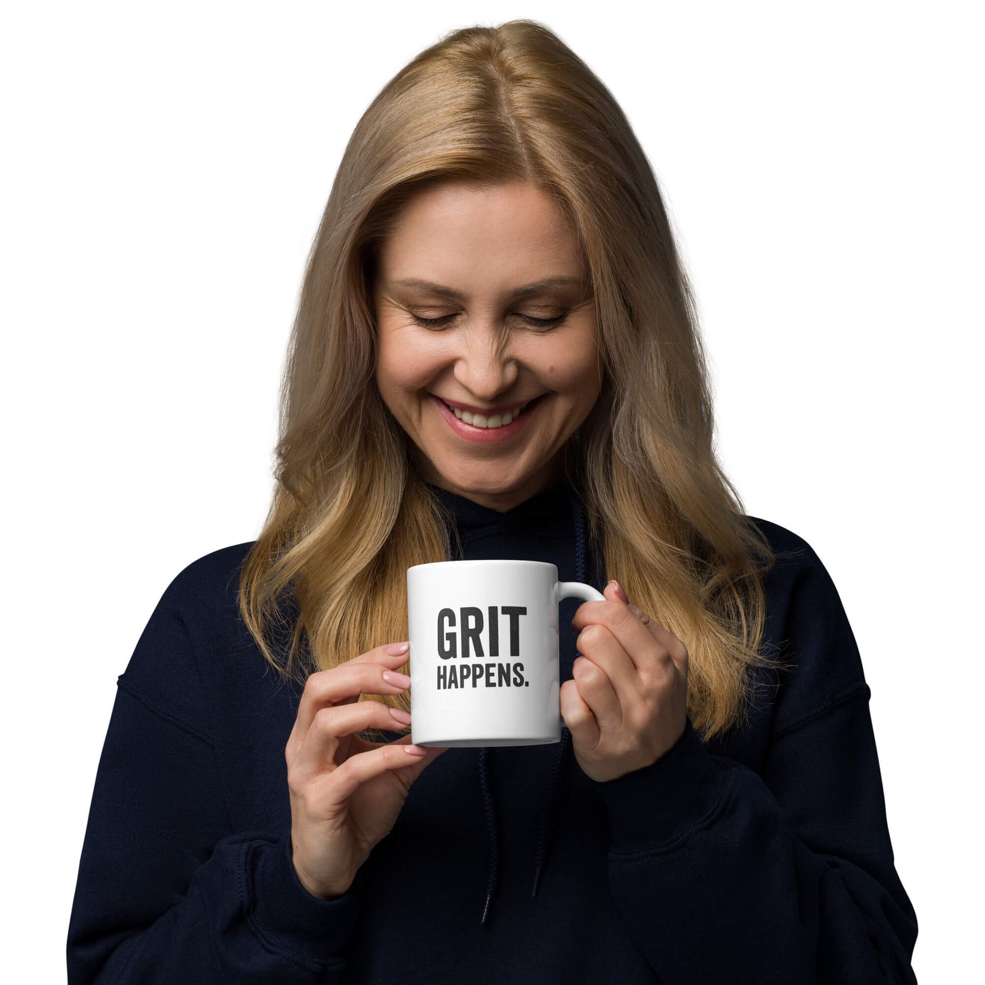 Woman smiling while holding the 11oz "Grit Happens" white ceramic coffee mug by Grit Collective.