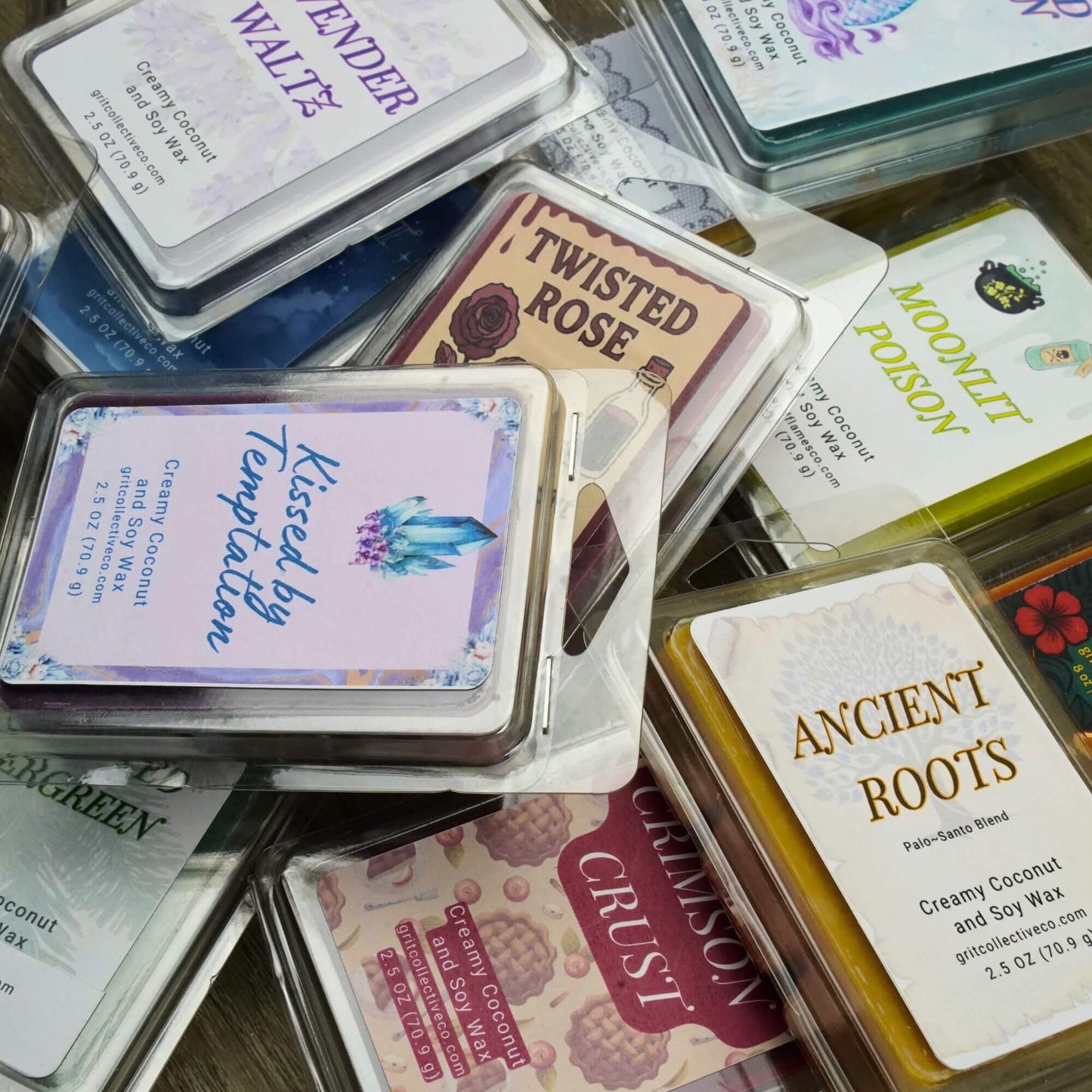 Pile of assorted Grit Collective creamy coconut and soy wax melt packages, showing different scents and labels.