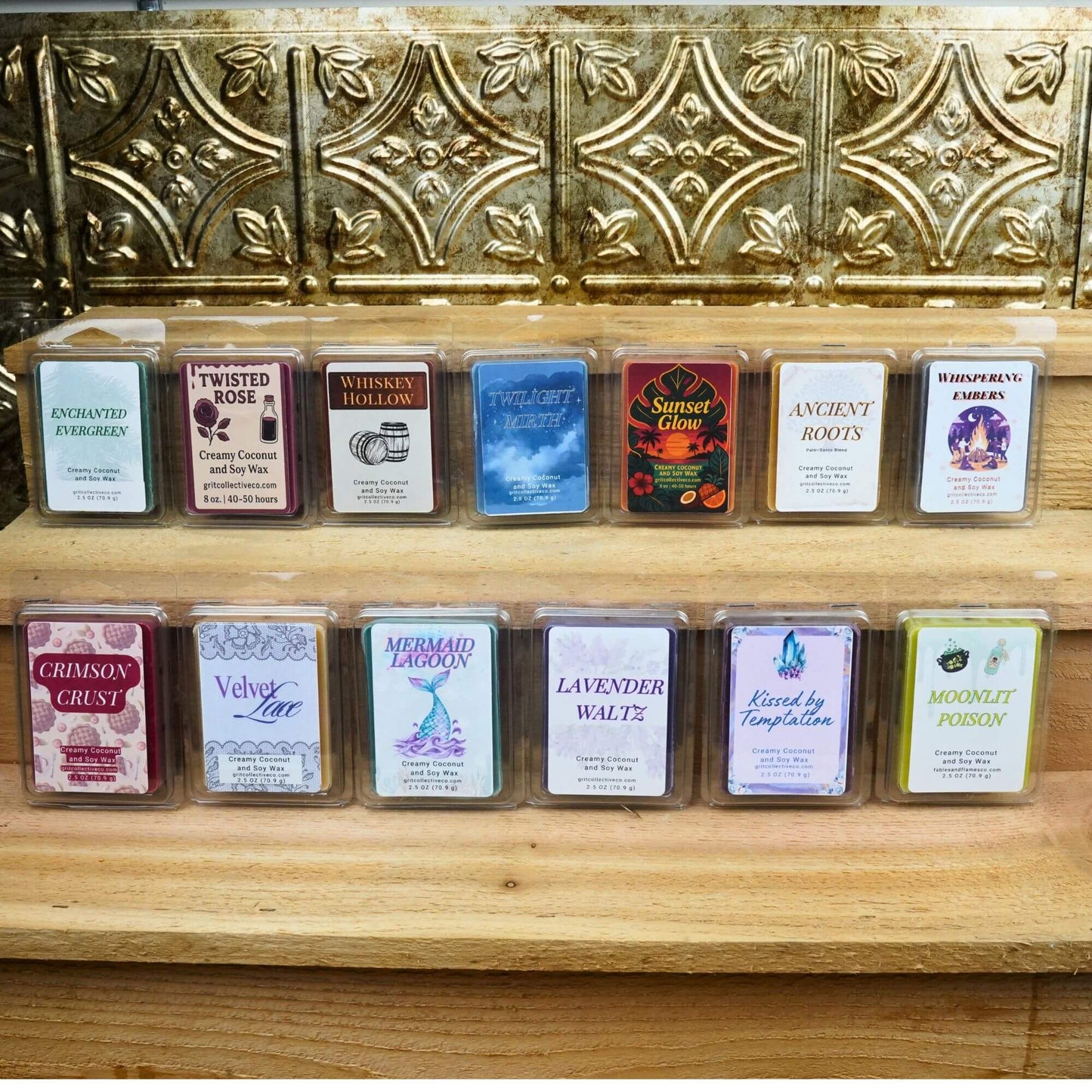 Variety of Grit Collective creamy coconut and soy wax melts in different scents and colors displayed on wooden shelves.