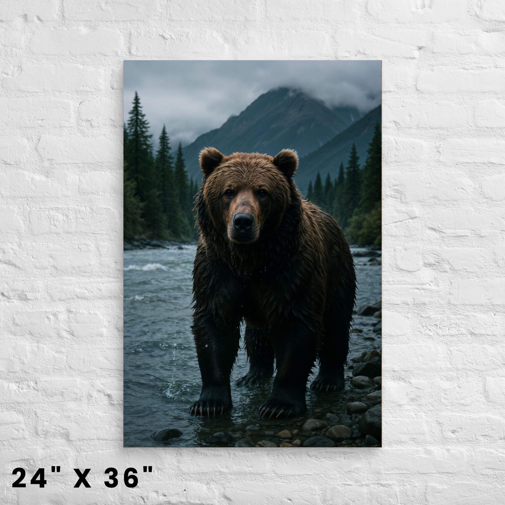 24 × 36-inch alpine grizzly bear canvas print featuring overcast peaks, evergreen forest, and rushing river against a bright white-brick backdrop.