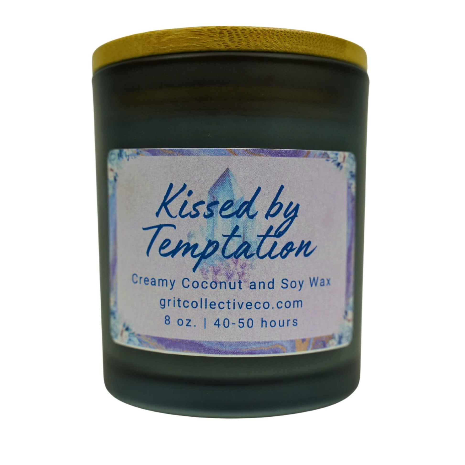Kissed by Temptation" creamy coconut and soy wax candle by Grit Collective Co. with a mystical crystal design and wooden lid.