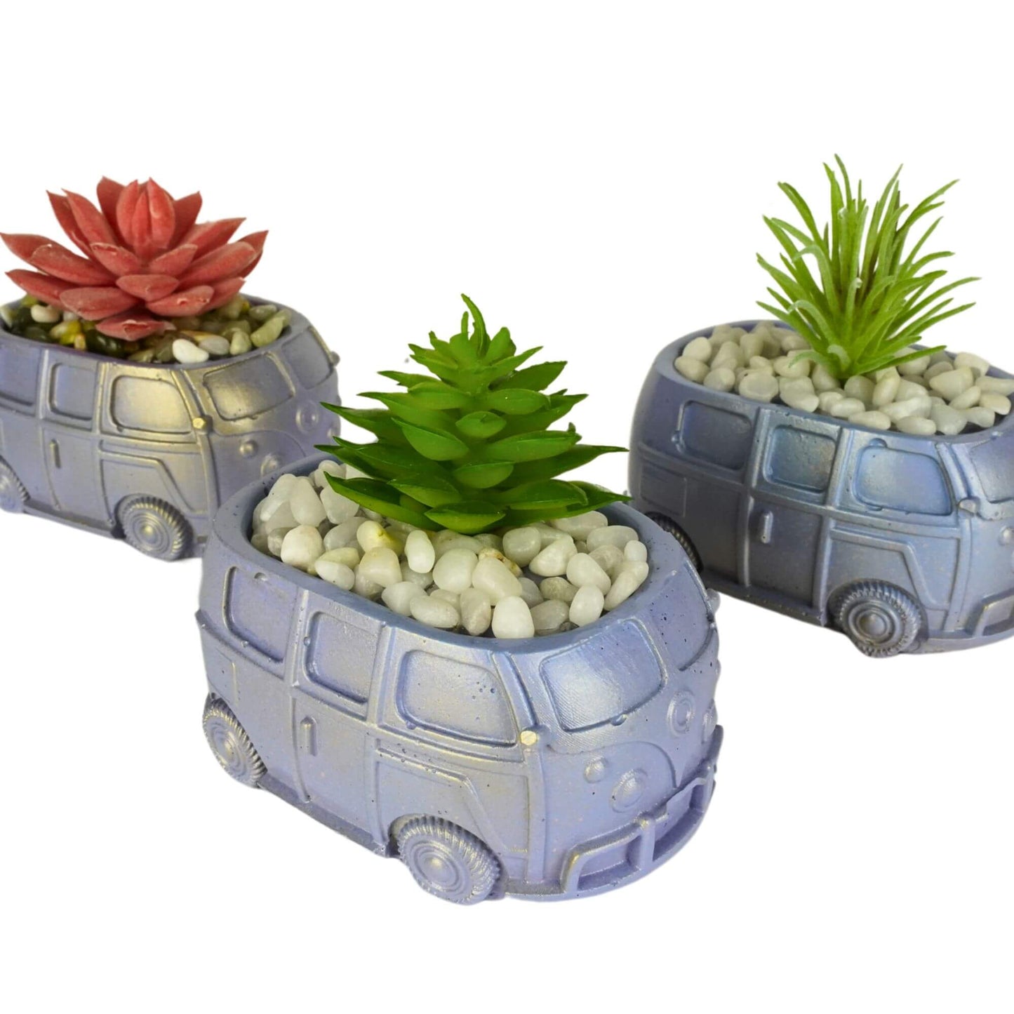 A group of three handmade mini retro bus concrete planters in metallic lavender, green, and blue finishes with assorted artificial succulents and pebbles.