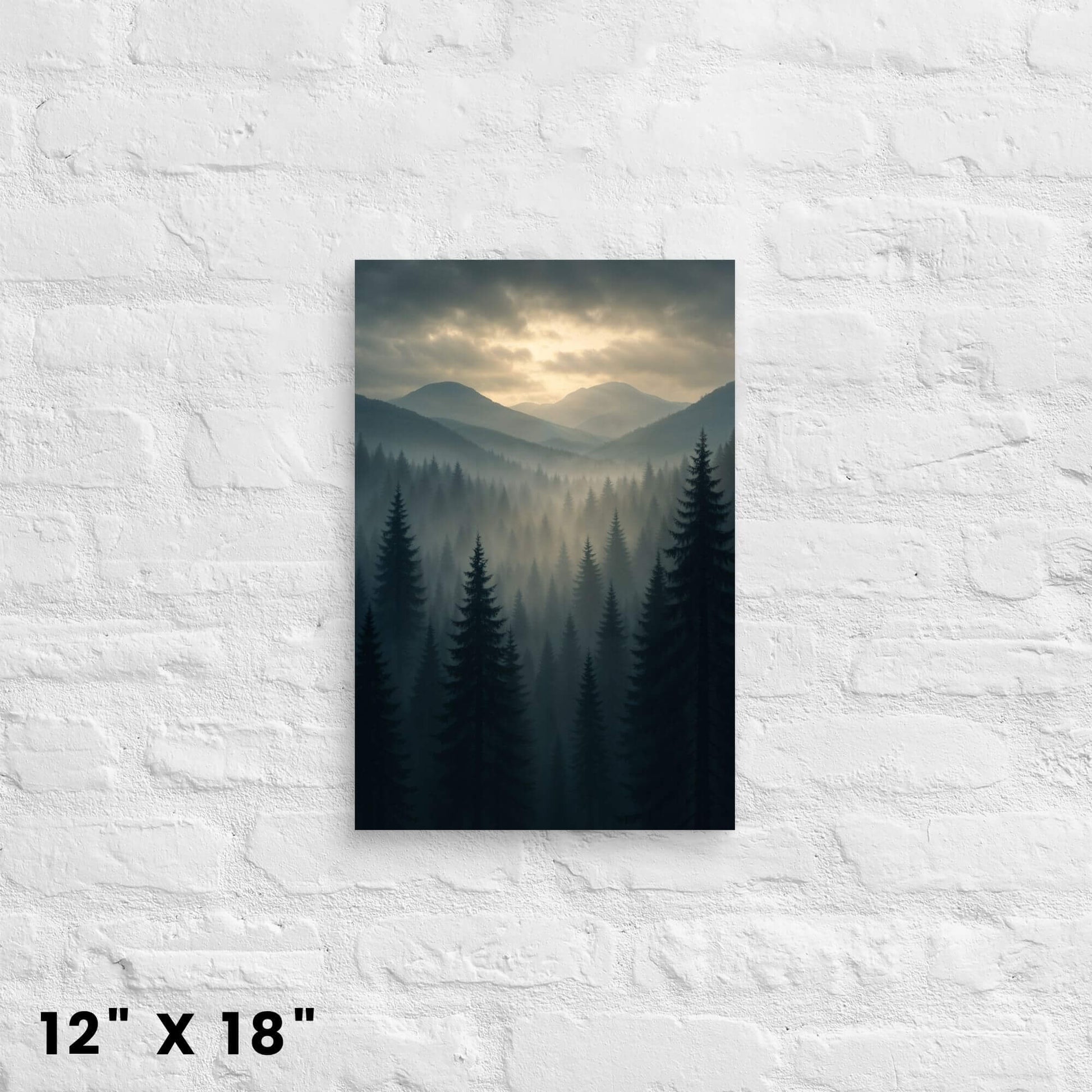 12 × 18-inch misty evergreen landscape canvas wall art featuring layered mountains at dawn, mounted on a white-brick wall.