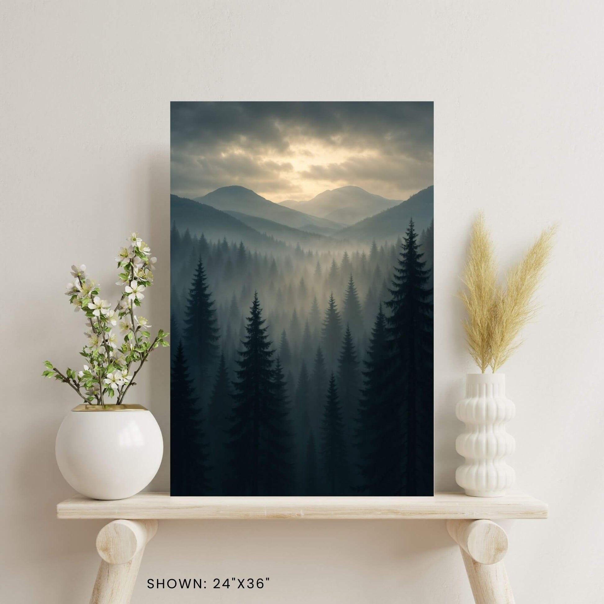 24 × 36-inch mist-laden mountain forest canvas print styled on a minimalist shelf with ceramic vase florals and pampas grass for calming nature décor.