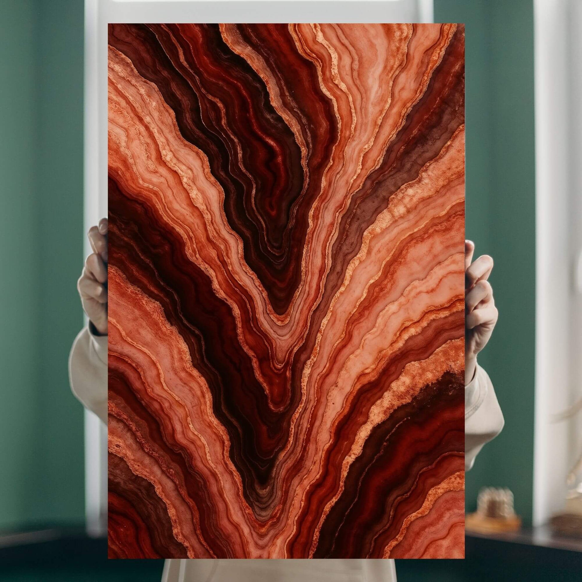 Person holding a molten-agate vein canvas print to show real-life scale, intricate layering, and vivid rust-to-chianti palette.