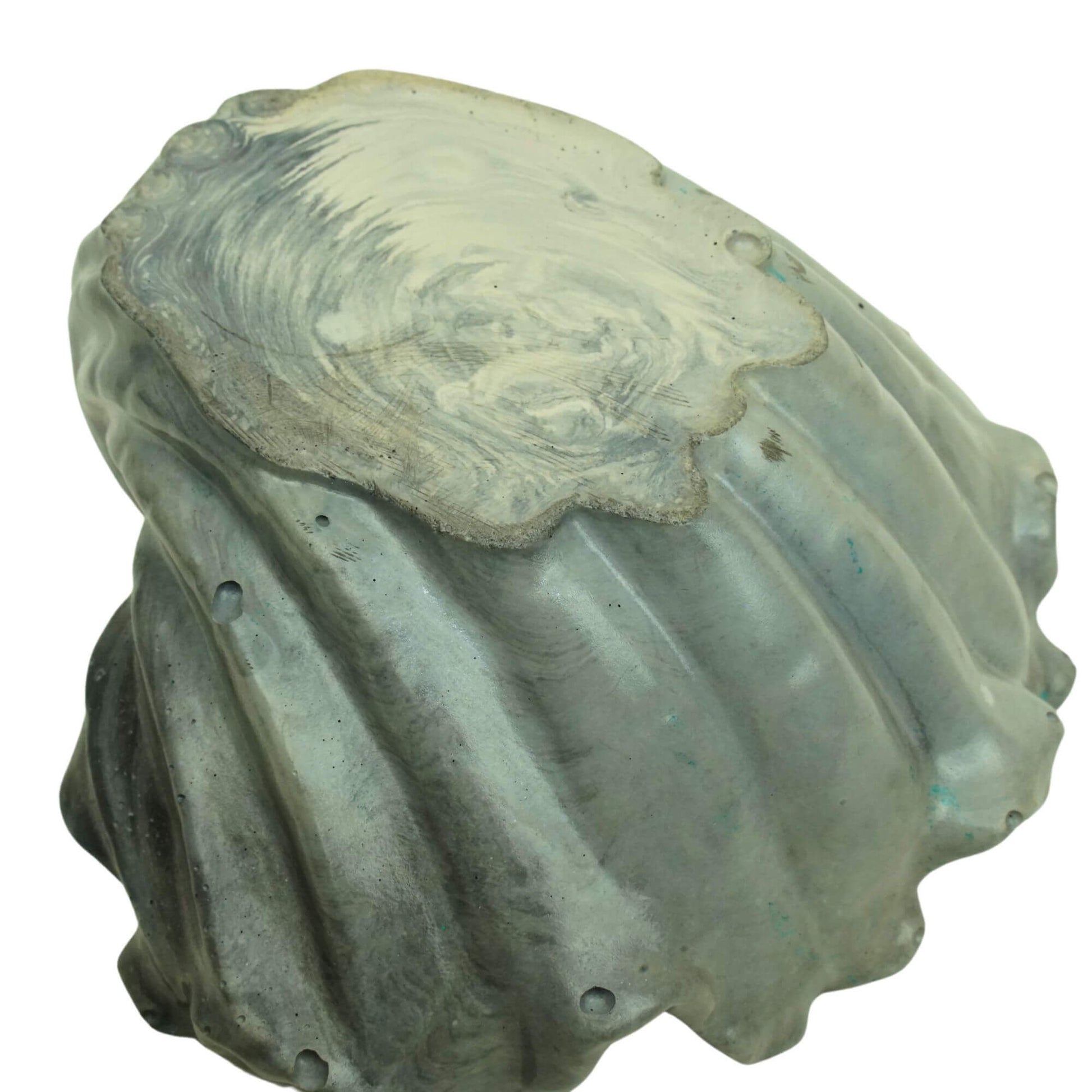 Bottom and side view of a gray or lavender tide Ocean Bowl, highlighting the handcrafted concrete texture.