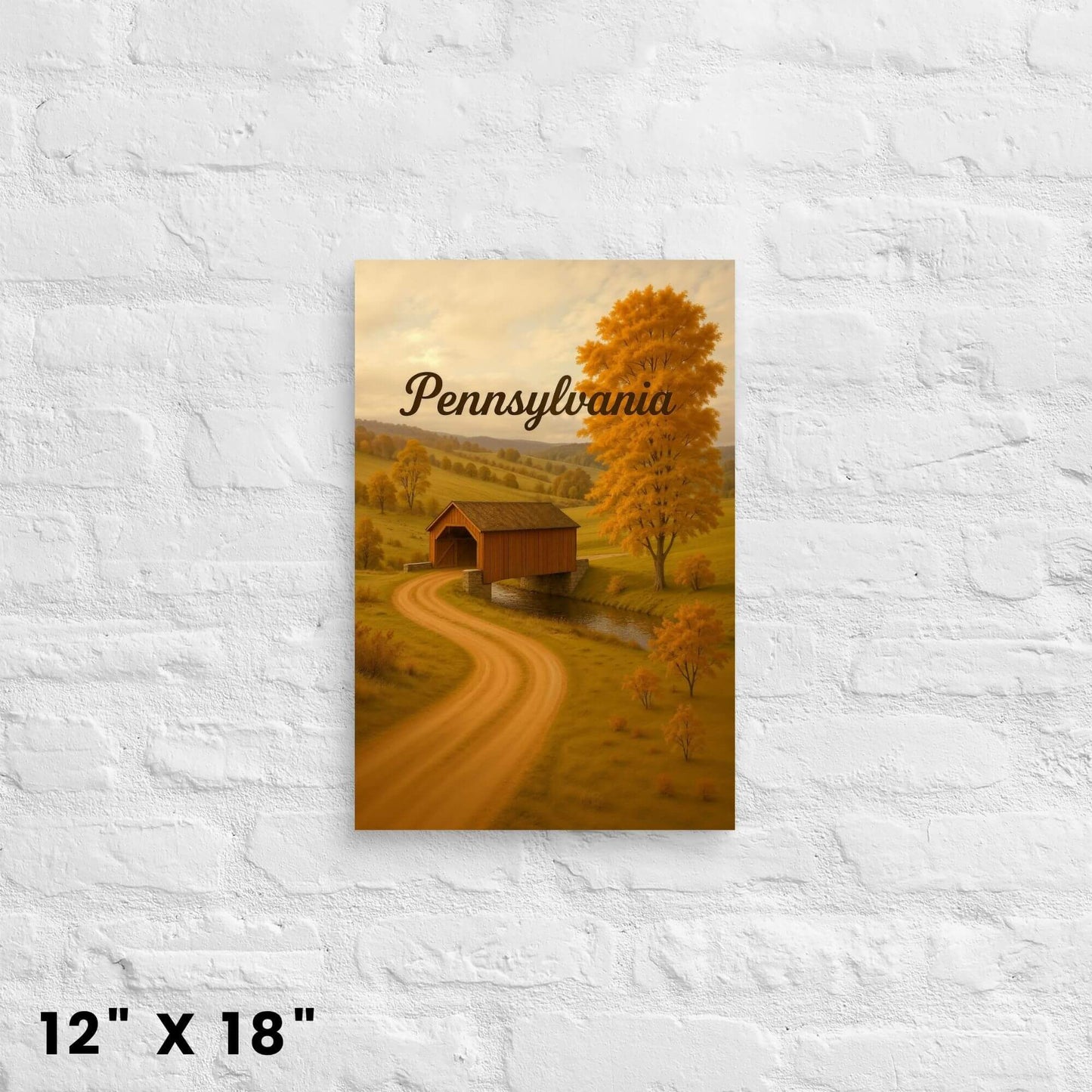 12"x18" canvas print of a covered bridge over a stream in a fall Pennsylvania setting, mounted on
a white brick wall.