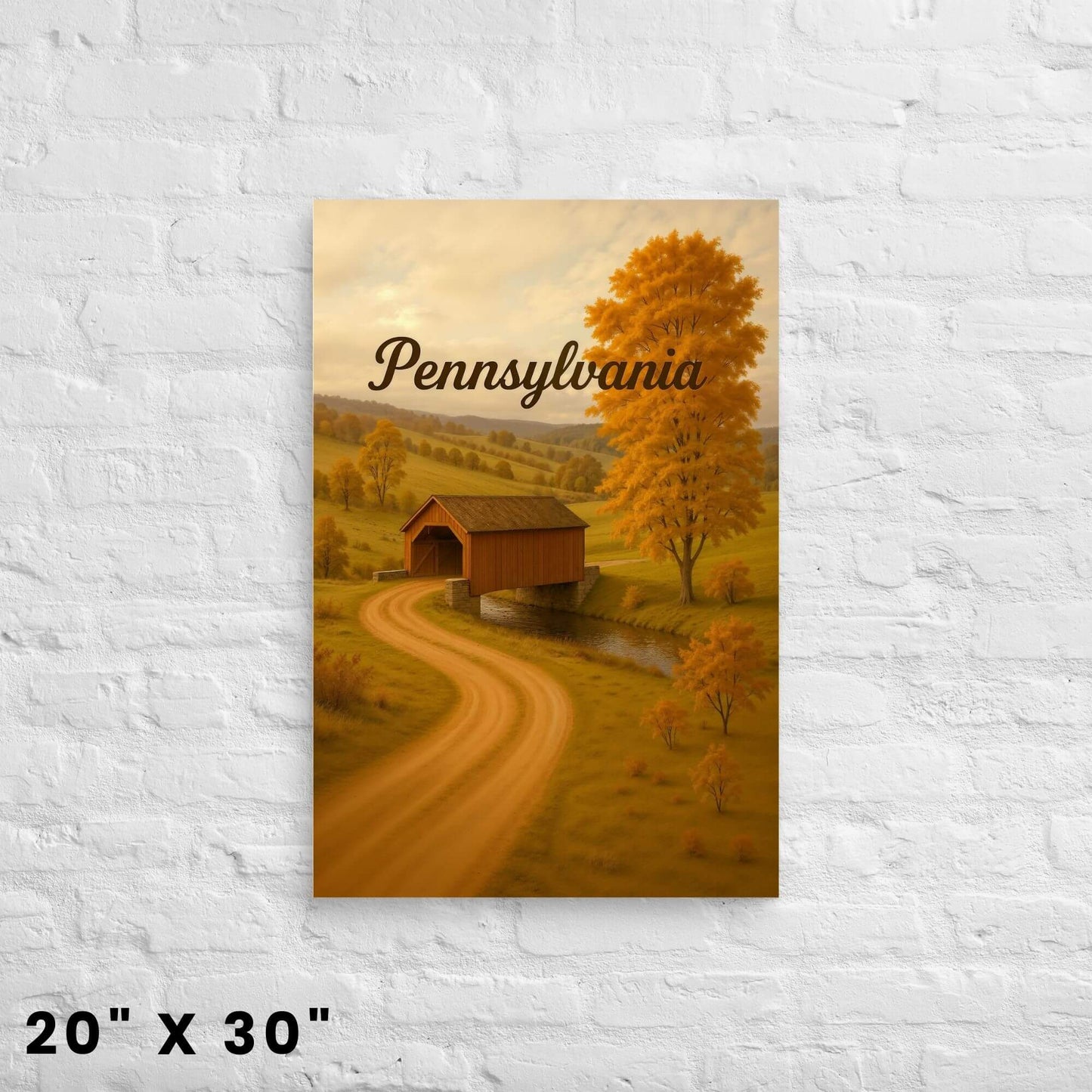 20"x30" canvas print of a picturesque covered bridge scene with fall colors in Pennsylvania,
hanging on a white brick wall.