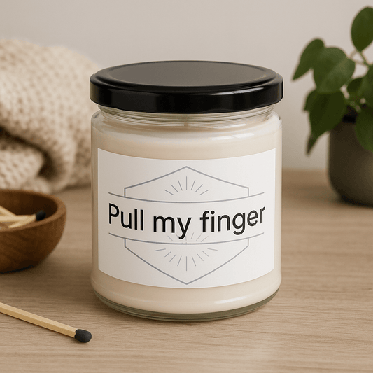 Close-up of "Pull my finger" label on a 9oz soy wax candle.