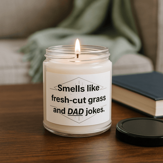 Smells like fresh-cut grass and DAD jokes" soy candle in a glass jar on a wooden table.