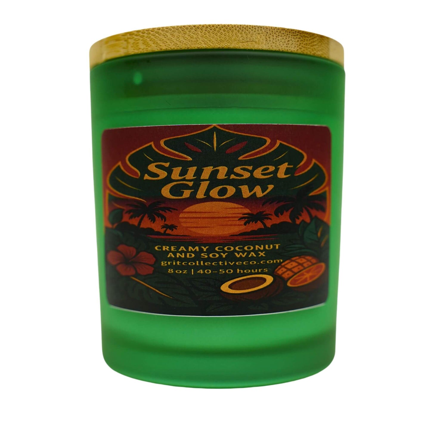Sunset Glow" creamy coconut and soy wax candle by Grit Collective Co. in a green glass jar with a tropical sunset label and bamboo lid.