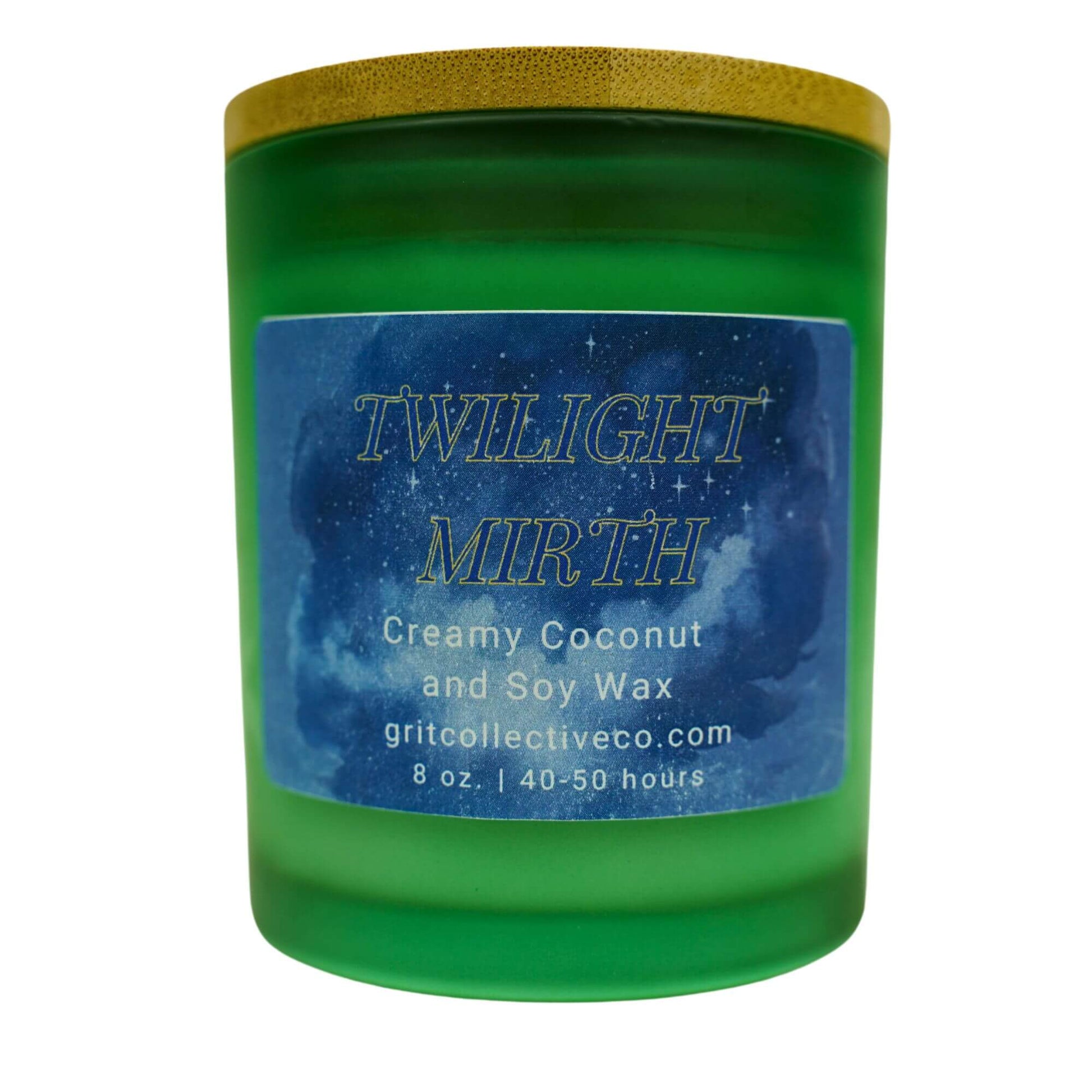 Twilight Mirth" creamy coconut and soy wax candle by Grit Collective Co. in a green glass jar with a starry label and bamboo lid.