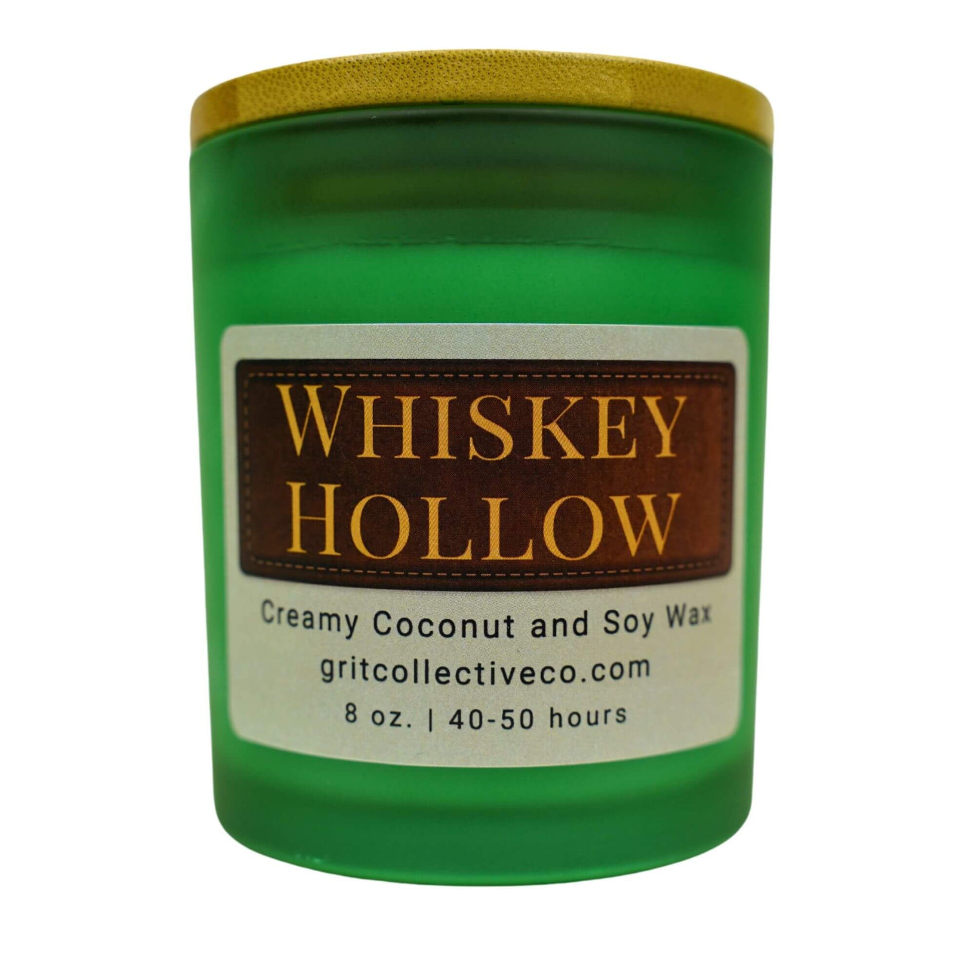 Whiskey Hollow" creamy coconut and soy wax candle by Grit Collective Co. in a green glass jar with a rustic label and bamboo lid.