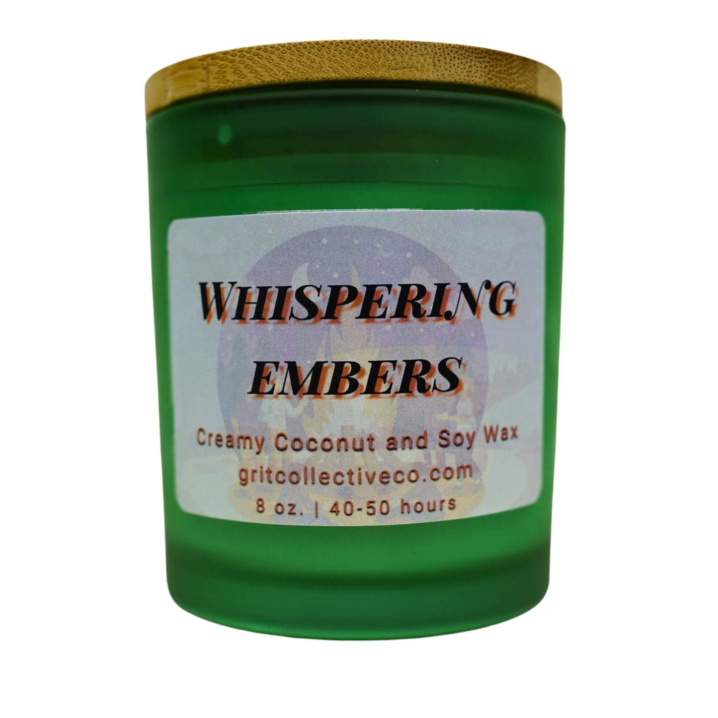 Whispering Embers" creamy coconut and soy wax candle by Grit Collective Co. in a green glass jar with an ethereal design label and bamboo lid.