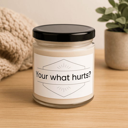 Your what hurts?" scented soy candle on a wooden surface next to a cozy knitted throw.