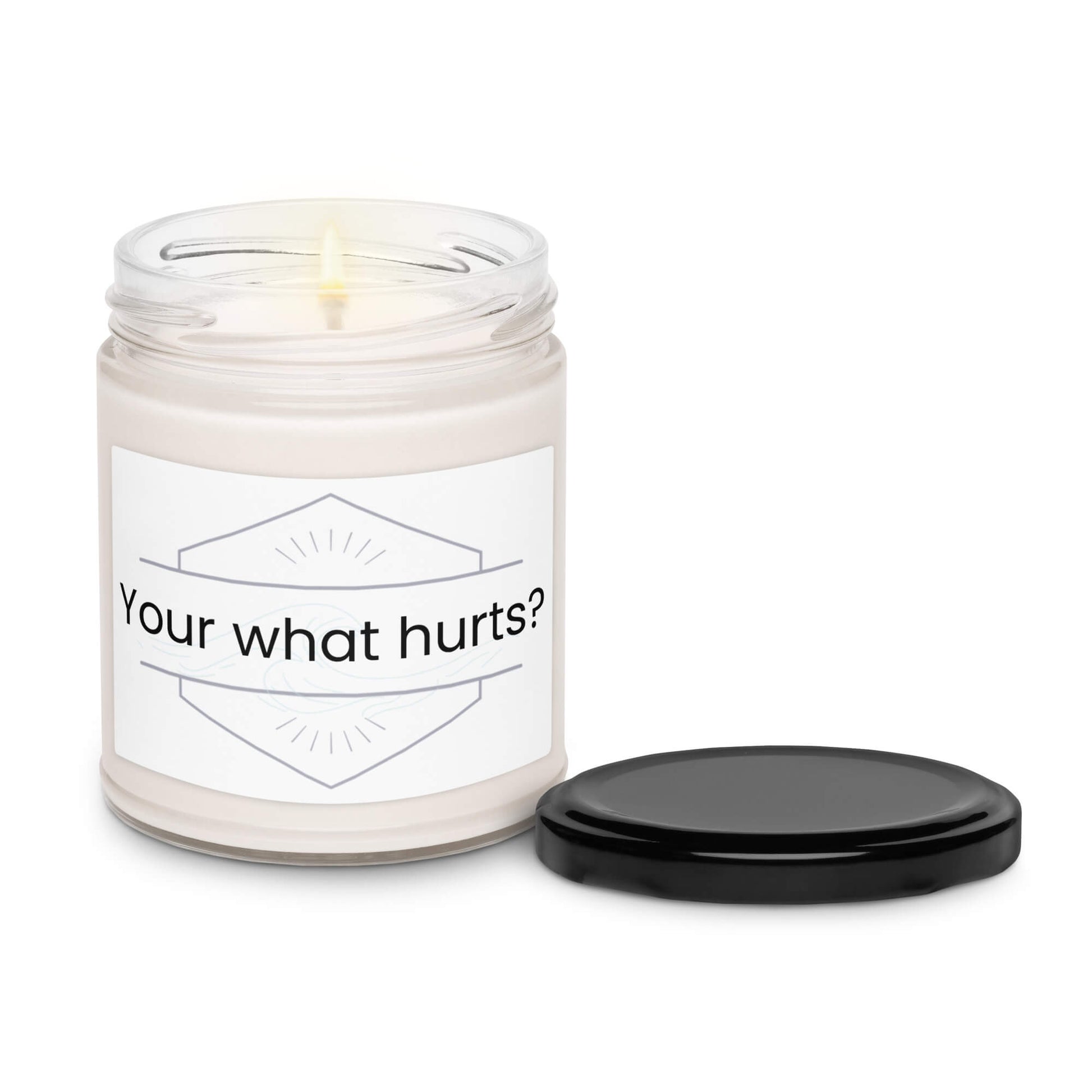 Your what hurts?" soy candle with the black lid removed, showing a gentle flame.