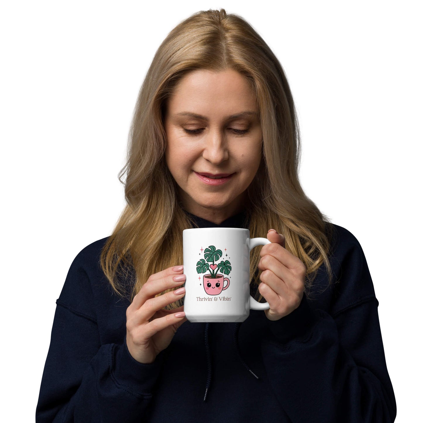 Woman holding a Grit Collective Kawaii Thriving Plant Pal design printed on a 15oz white glossy ceramic coffee mug.