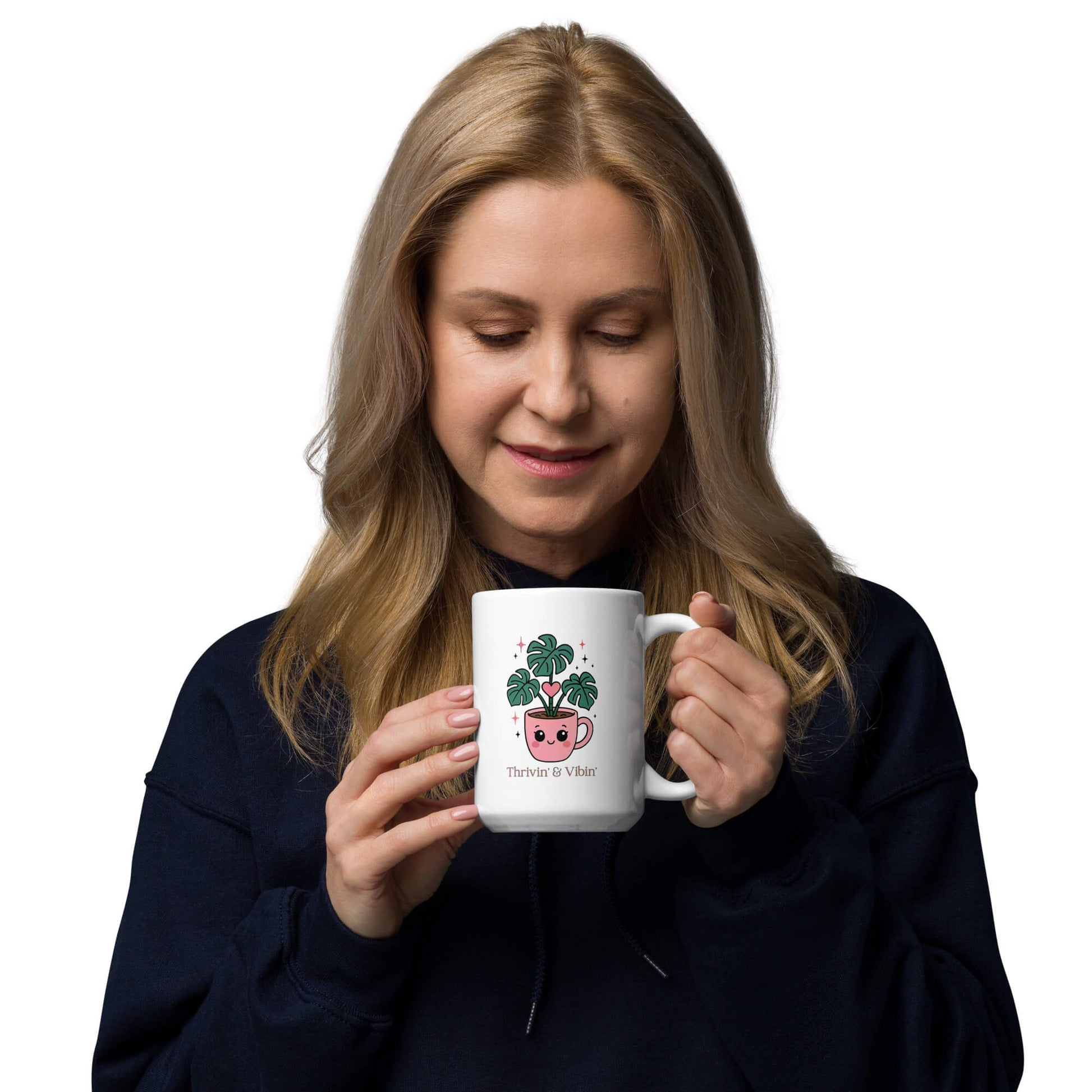 Woman holding a Grit Collective Kawaii Thriving Plant Pal design printed on a 15oz white glossy ceramic coffee mug.