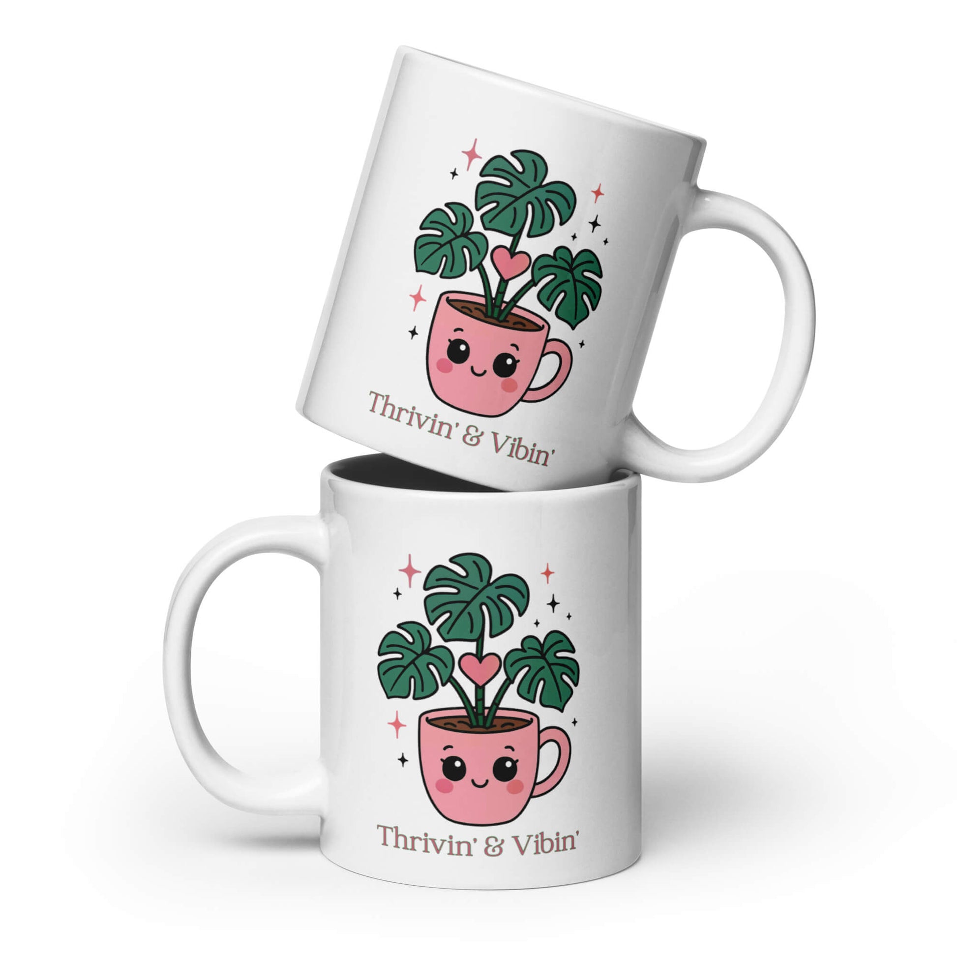 Two Grit Collective Kawaii Thriving Plant Pal design printed 20oz white glossy ceramic coffee mugs, one stacked on the other.