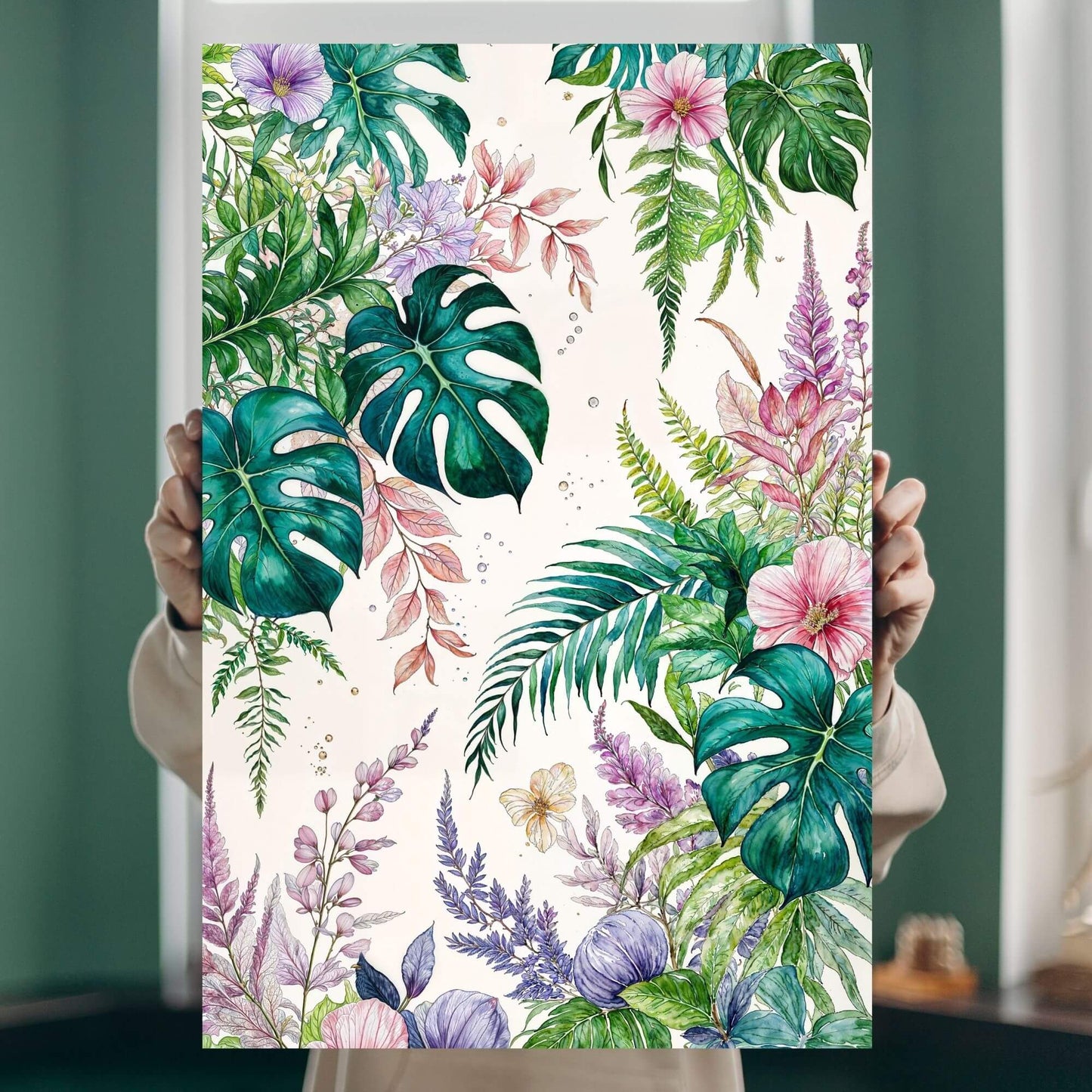 Person holding a canvas print of a tropical botanical watercolor illustration featuring leaves and flowers.